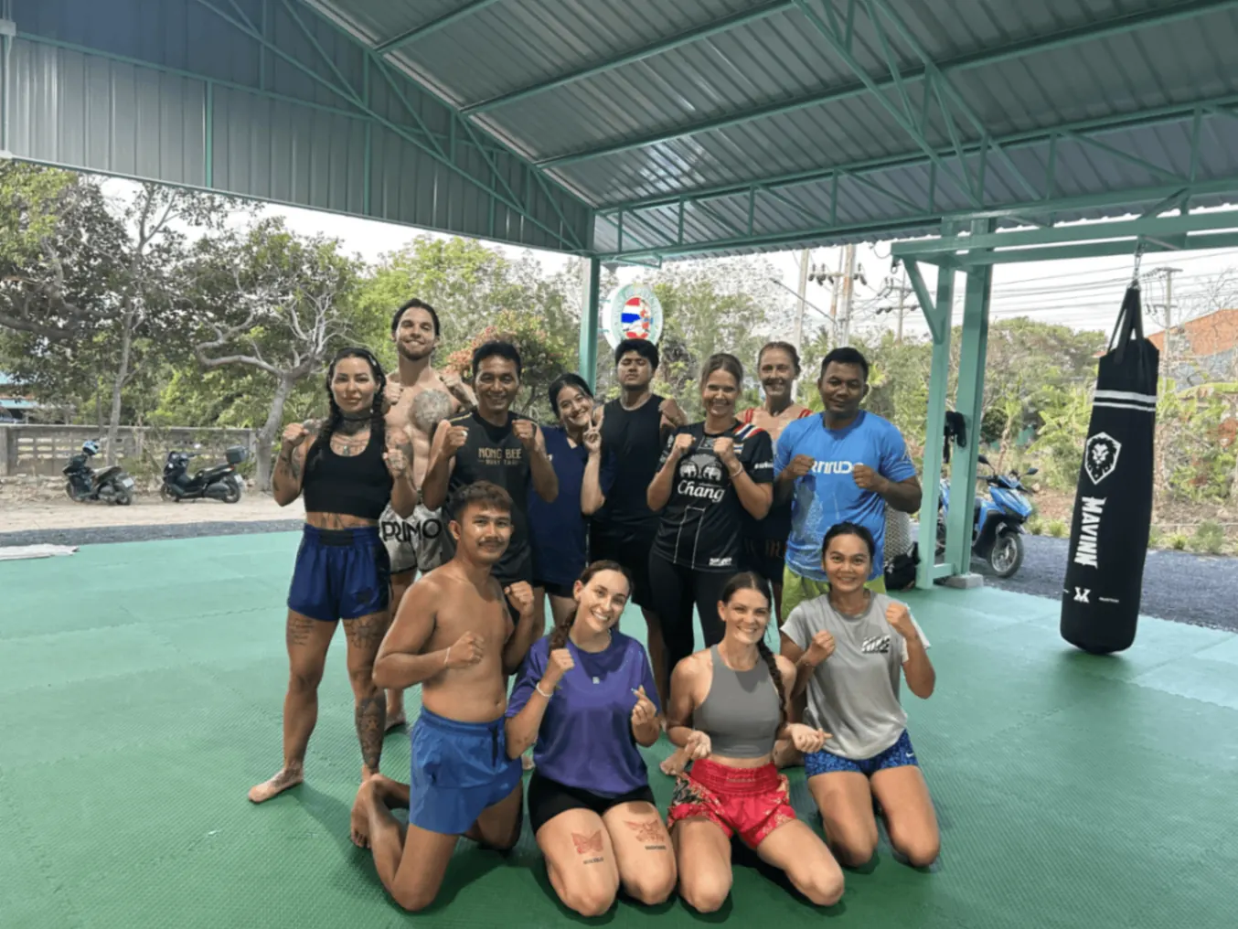 Group of students and trainers posing at Nong Bee Muay Thai gym
