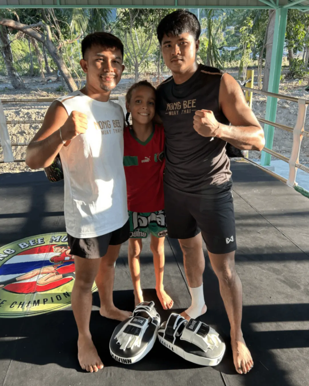 Trainers and young student posing