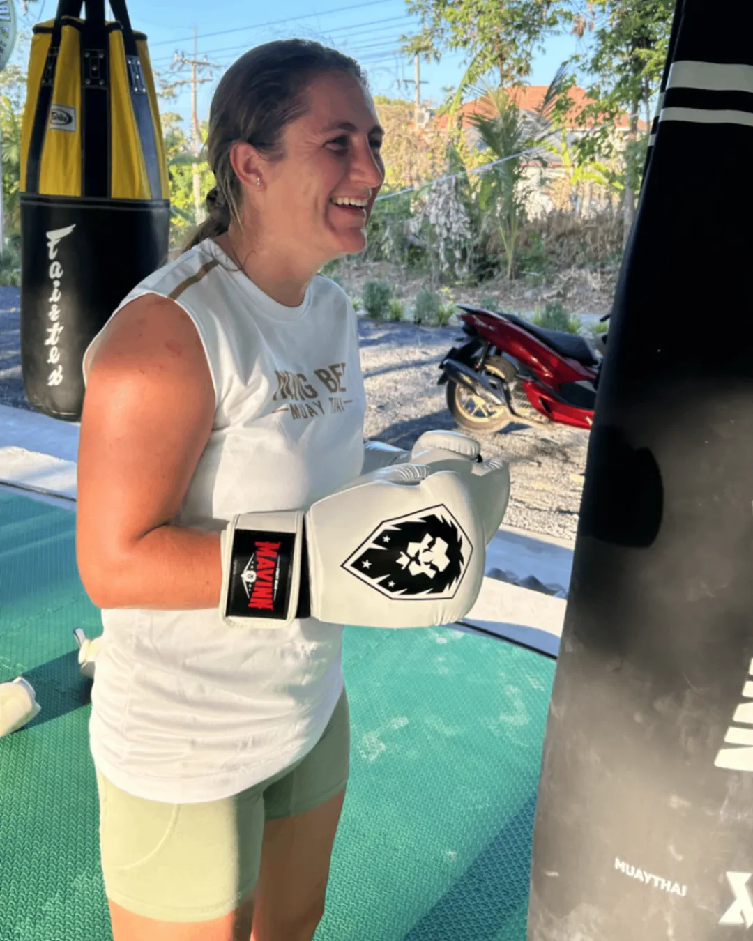 Female client at the heavy bag