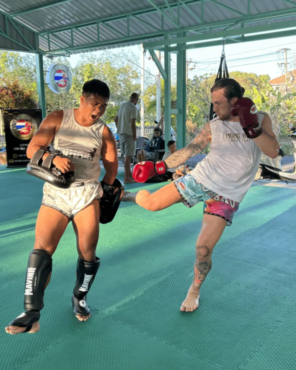 Client landing a kick on the pads