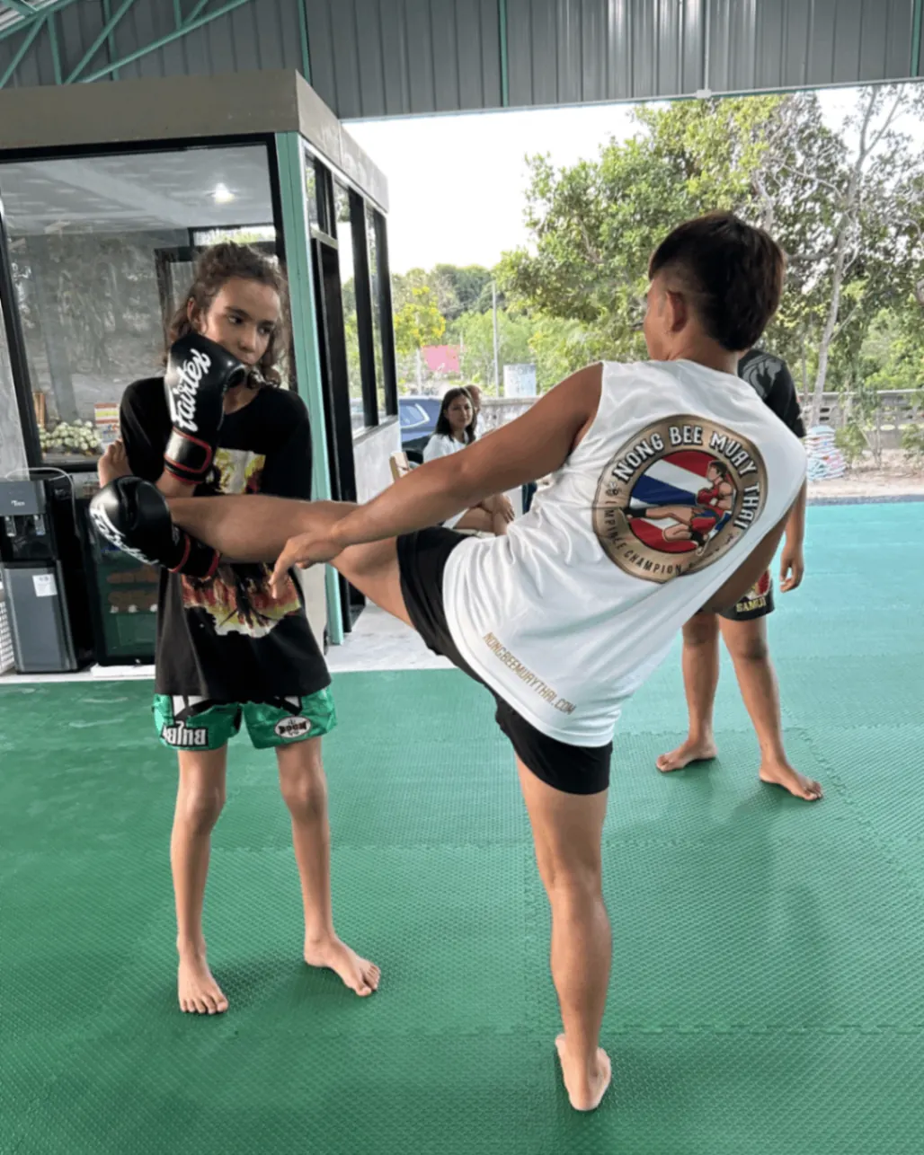 Young girl kick training with trainer